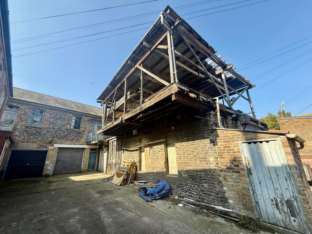Lot: 162 - TOWN CENTRE BUILDERS YARD/WORKSHOPS WITH PLANNING FOR REDEVELOPMENT - Buildings to right